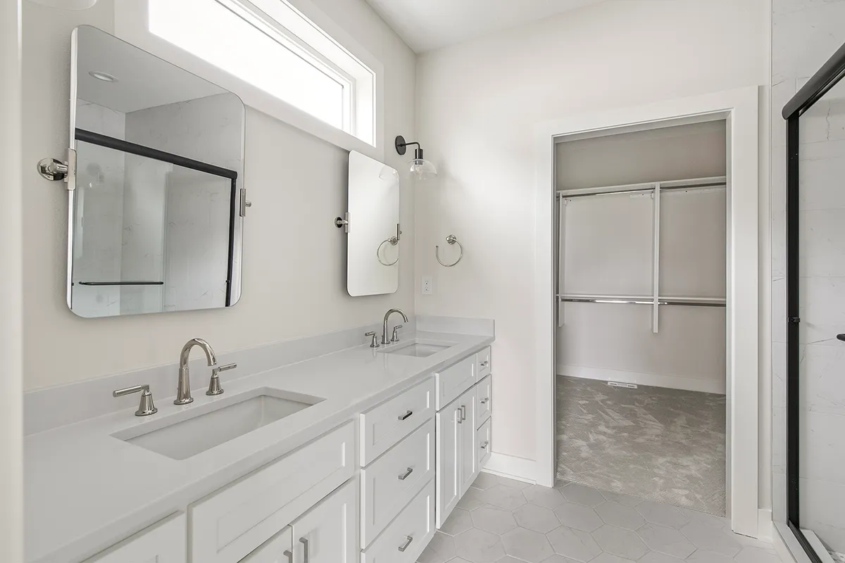 White bathroom with double sinks and vanity