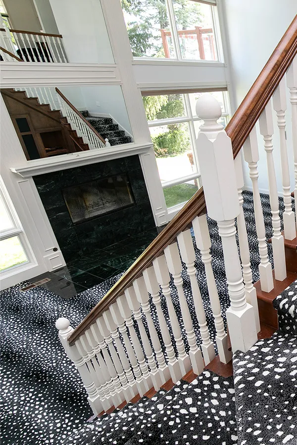 Dramatic black and white entryway and staircase with windows 