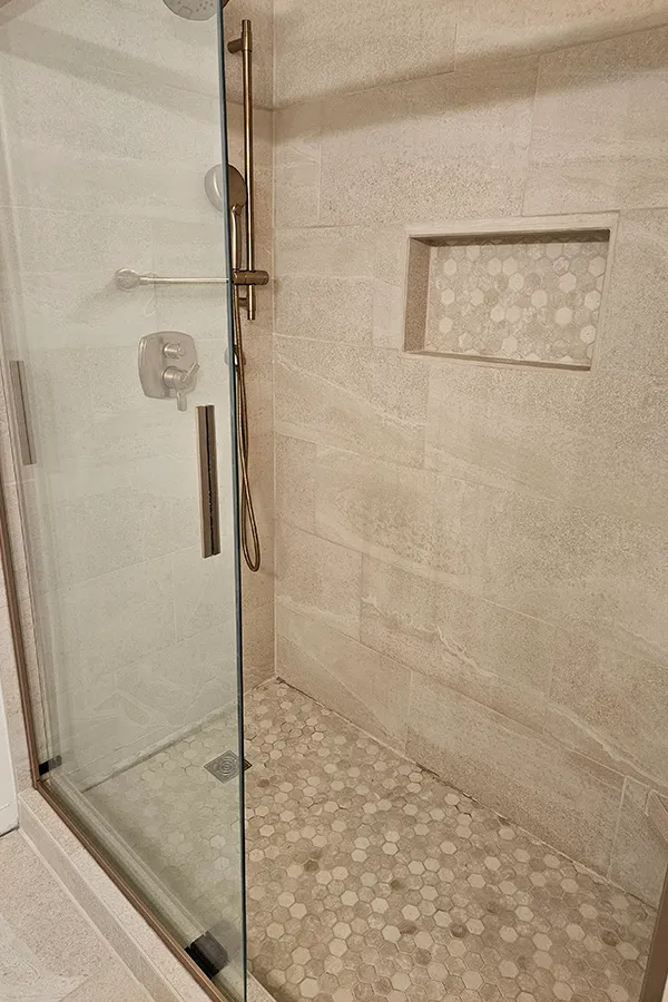 Custom walk-in glass enclosed shower stall 