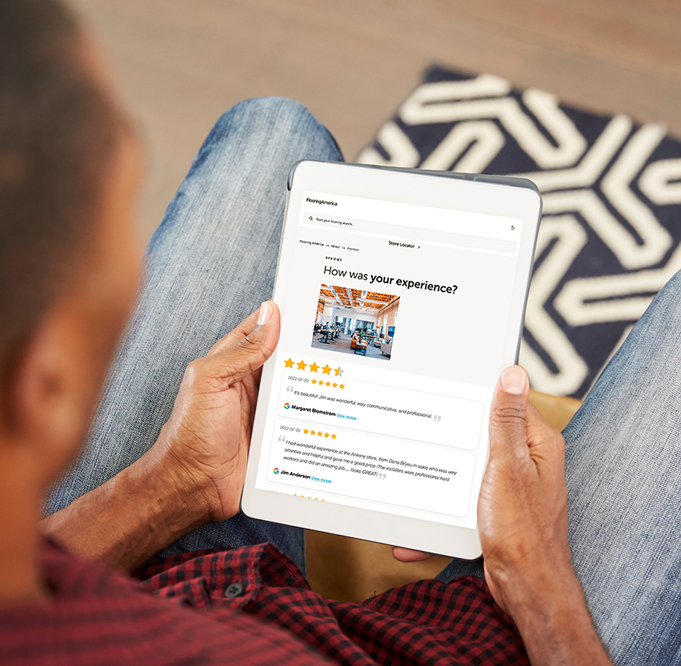 person holding tablet and reading reviews